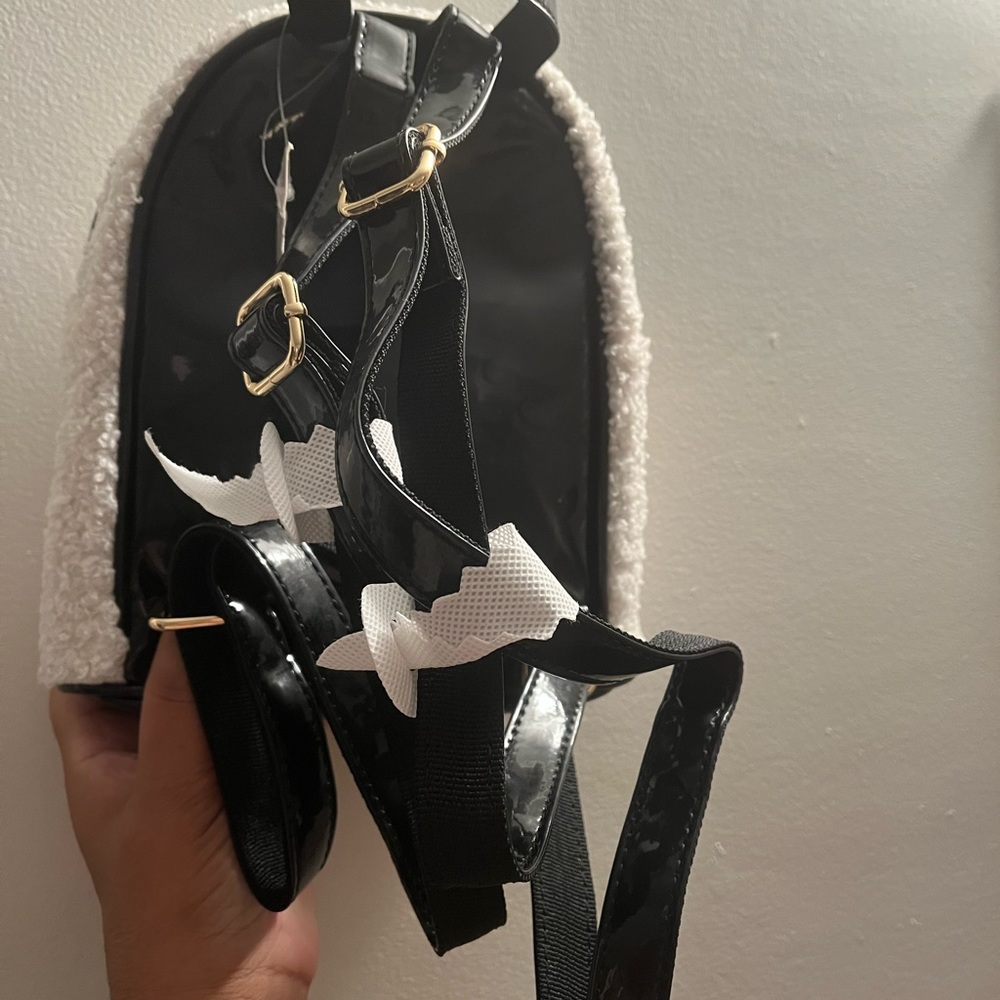 A brand new Mickey mouse back pack plus a four card holder zipper in the front